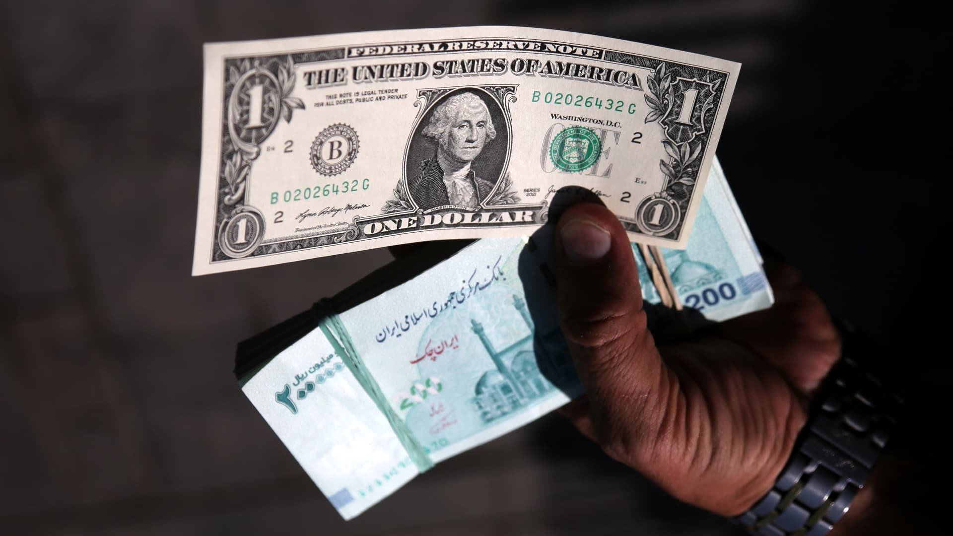 Iranian toman currency and US dollars in Tehran, showing the local currency impact of U.S. sanctions