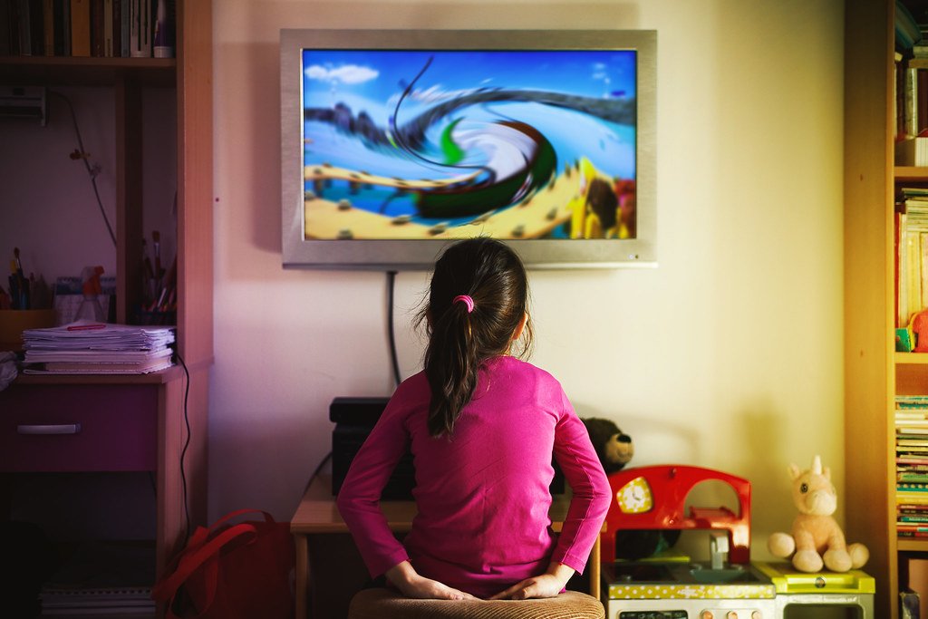 Small Girl is Watching a Cartoon